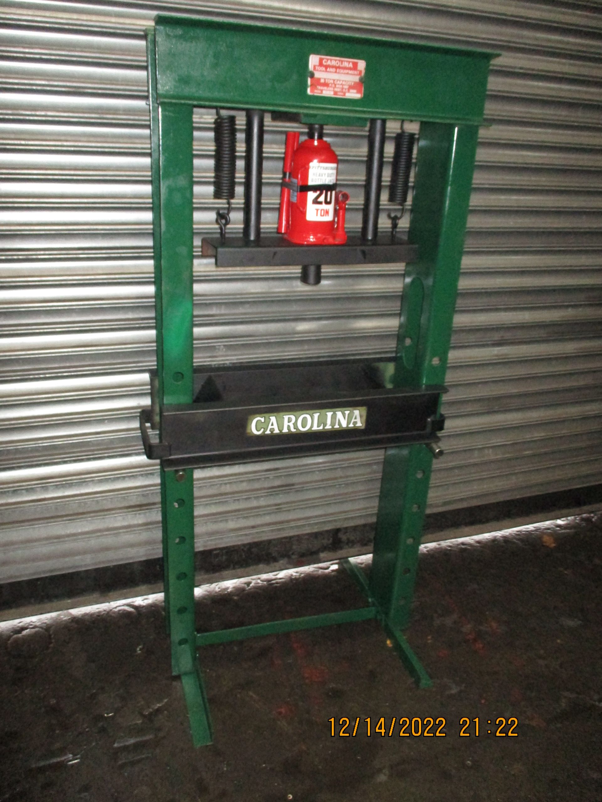 A green carolina machine with a red bottle on top