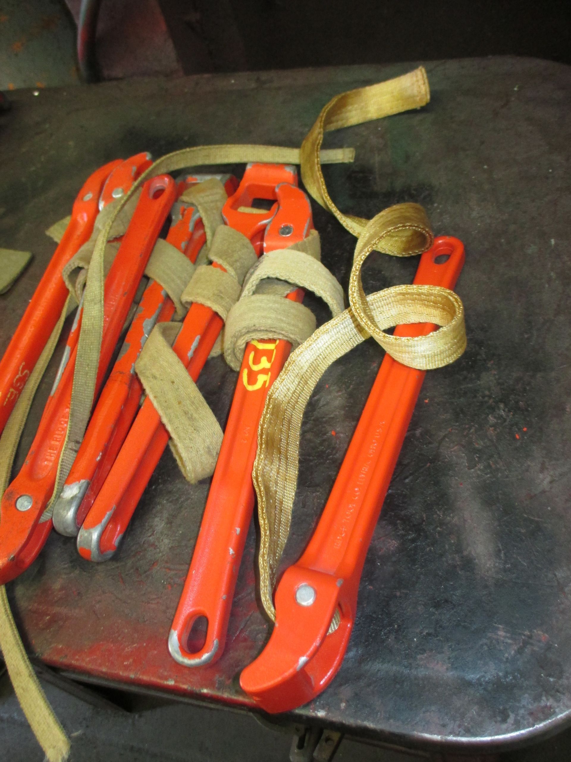 A bunch of orange wrenches with the number 135 on them