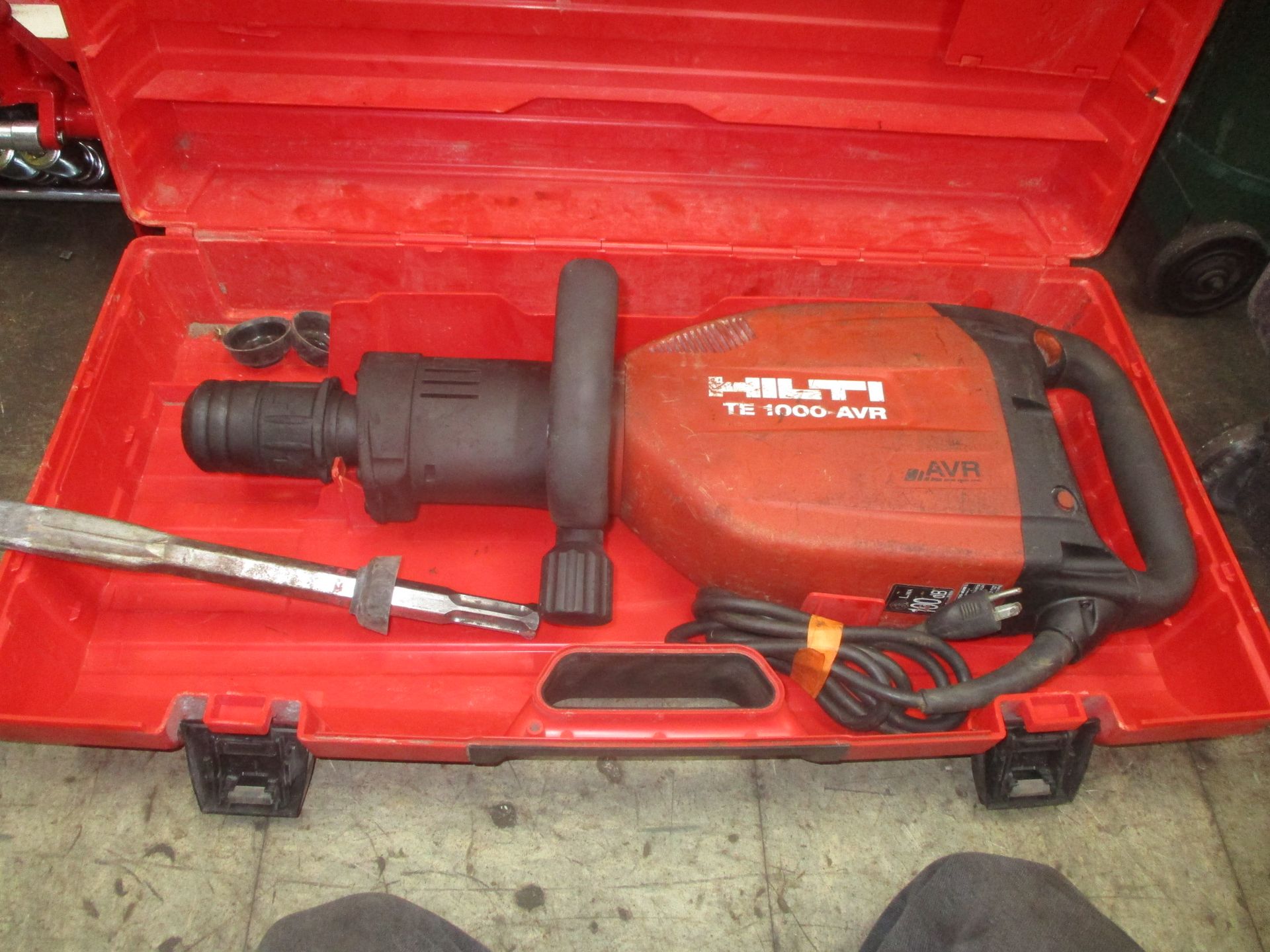 A red milti hammer is sitting in a red case.