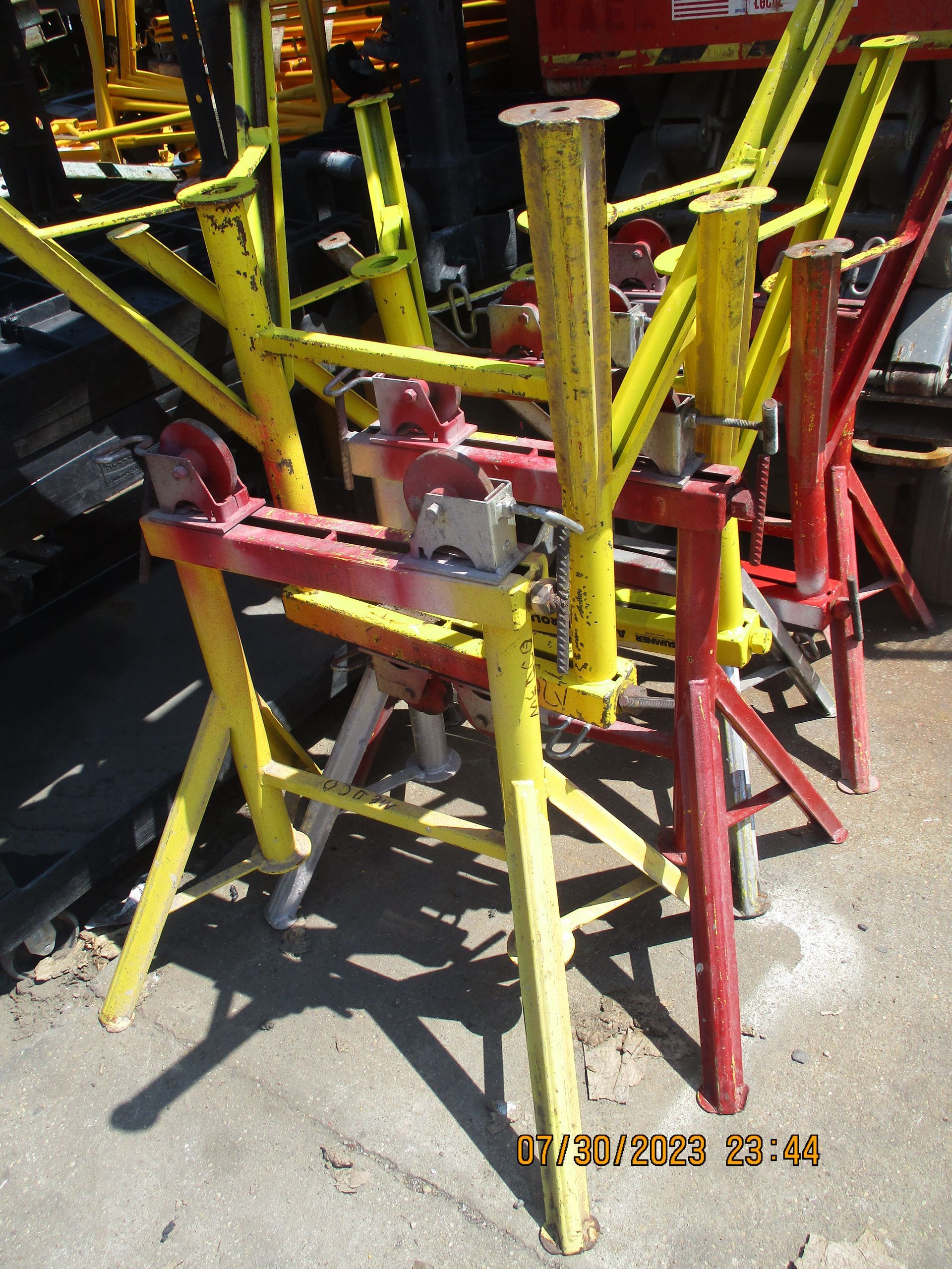 A bunch of yellow and red scaffolding sitting on the ground