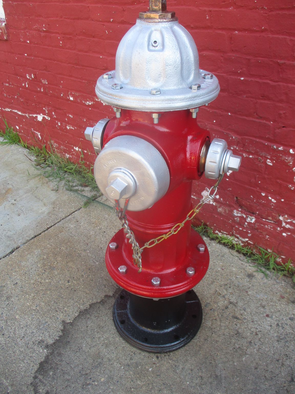 A red fire hydrant with a chain attached to it