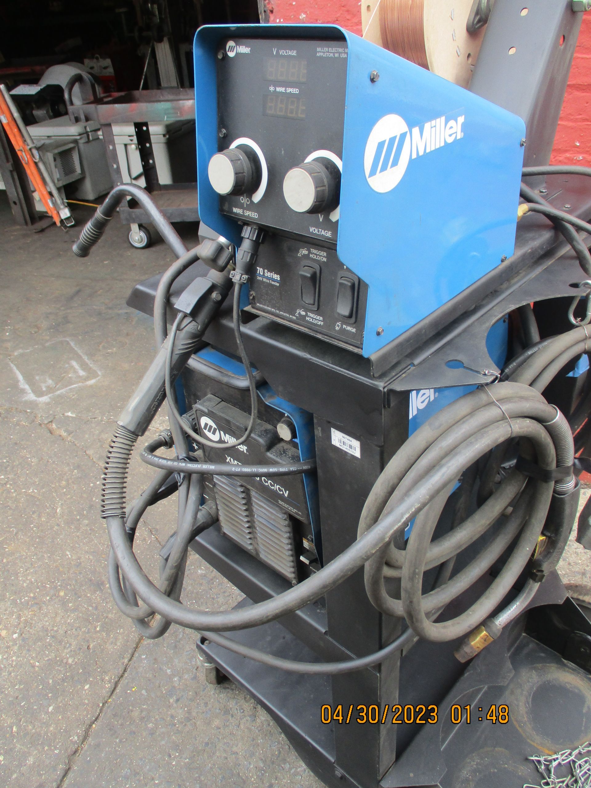 A miller welding machine is sitting on a cart