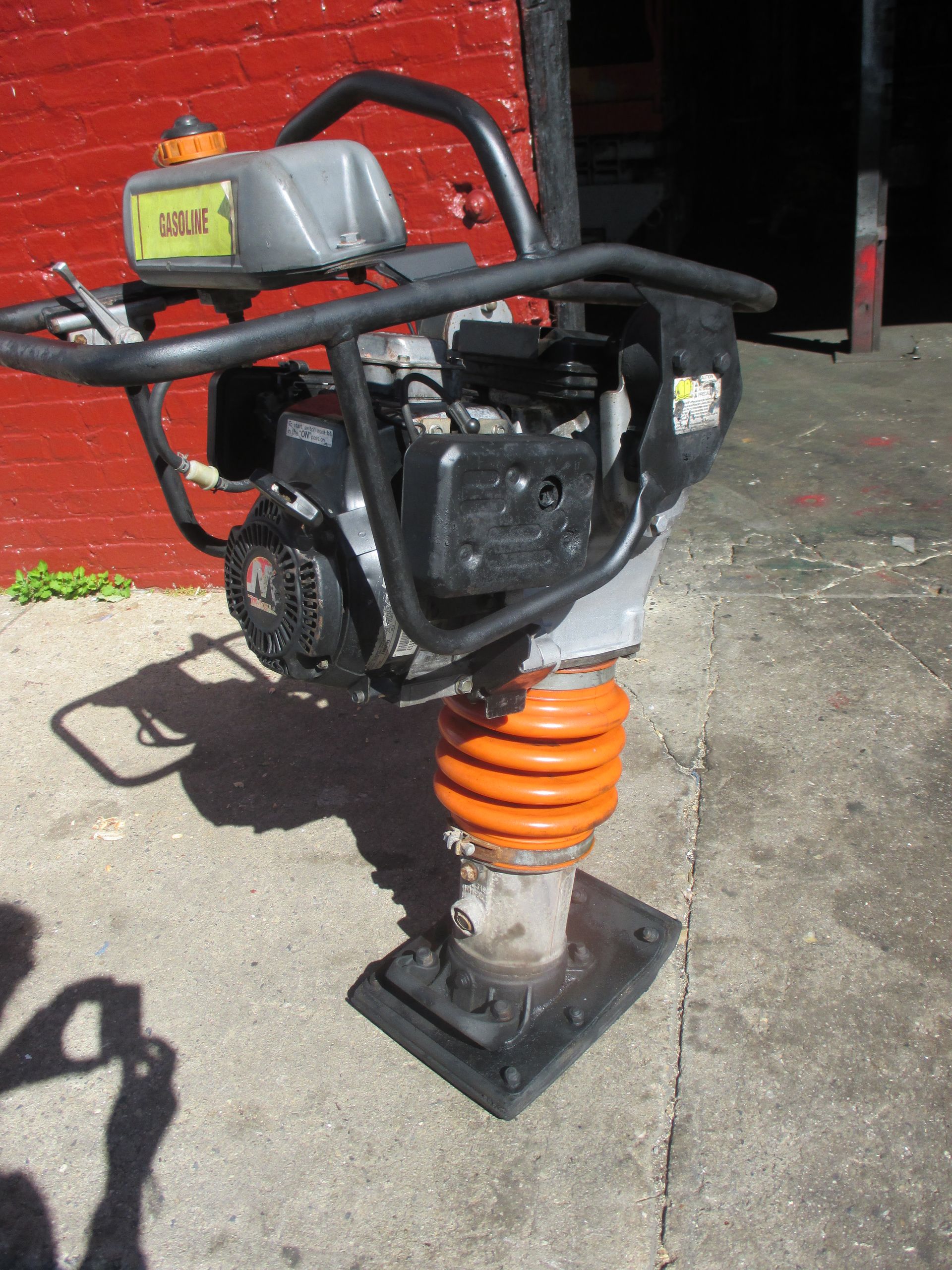 A black and orange machine with a sticker on it that says ' a ' on it