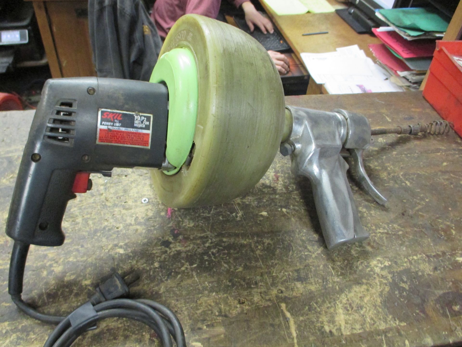 A drain cleaner is sitting on a wooden table