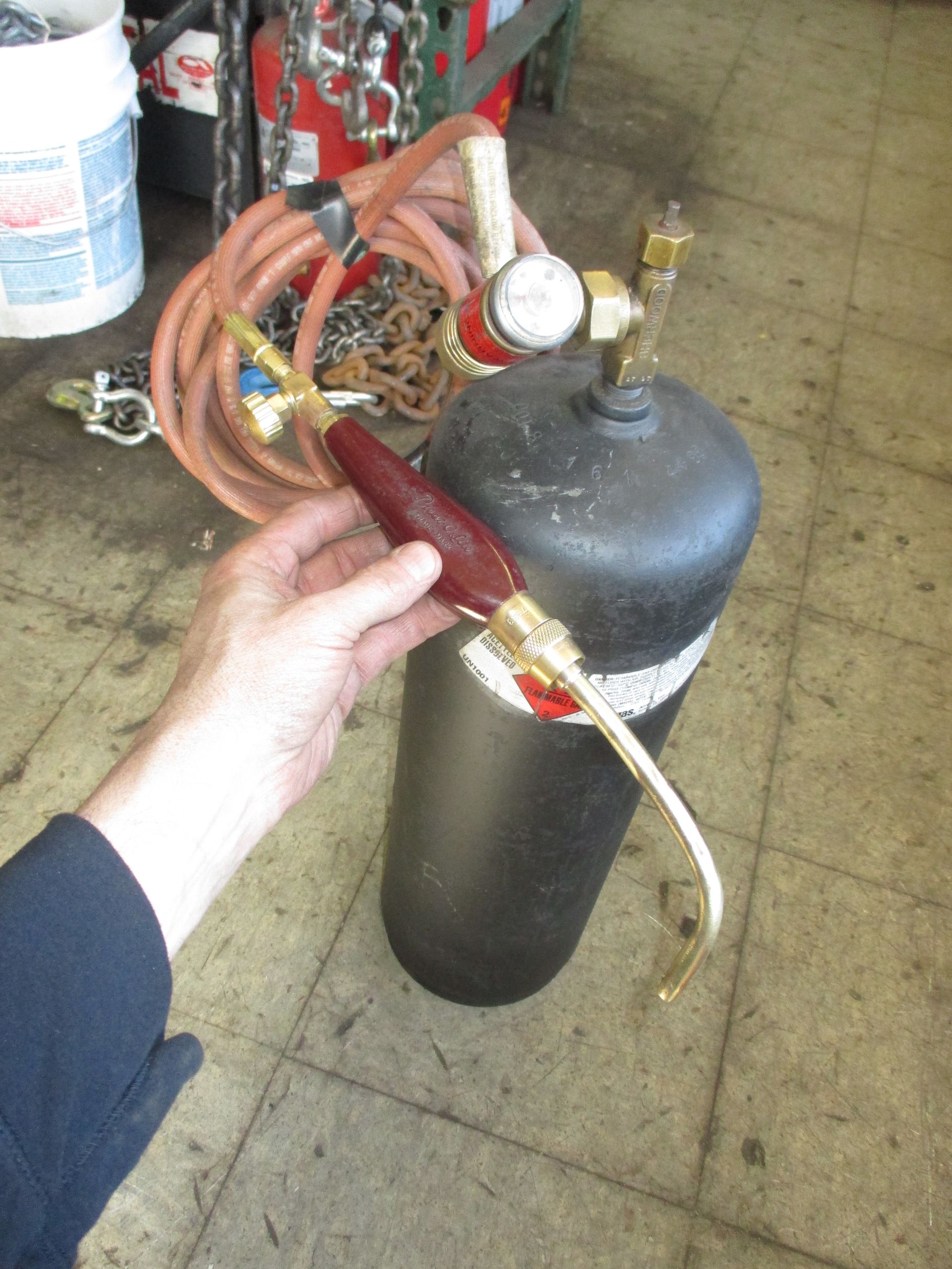 A person is holding a welding torch in their hand