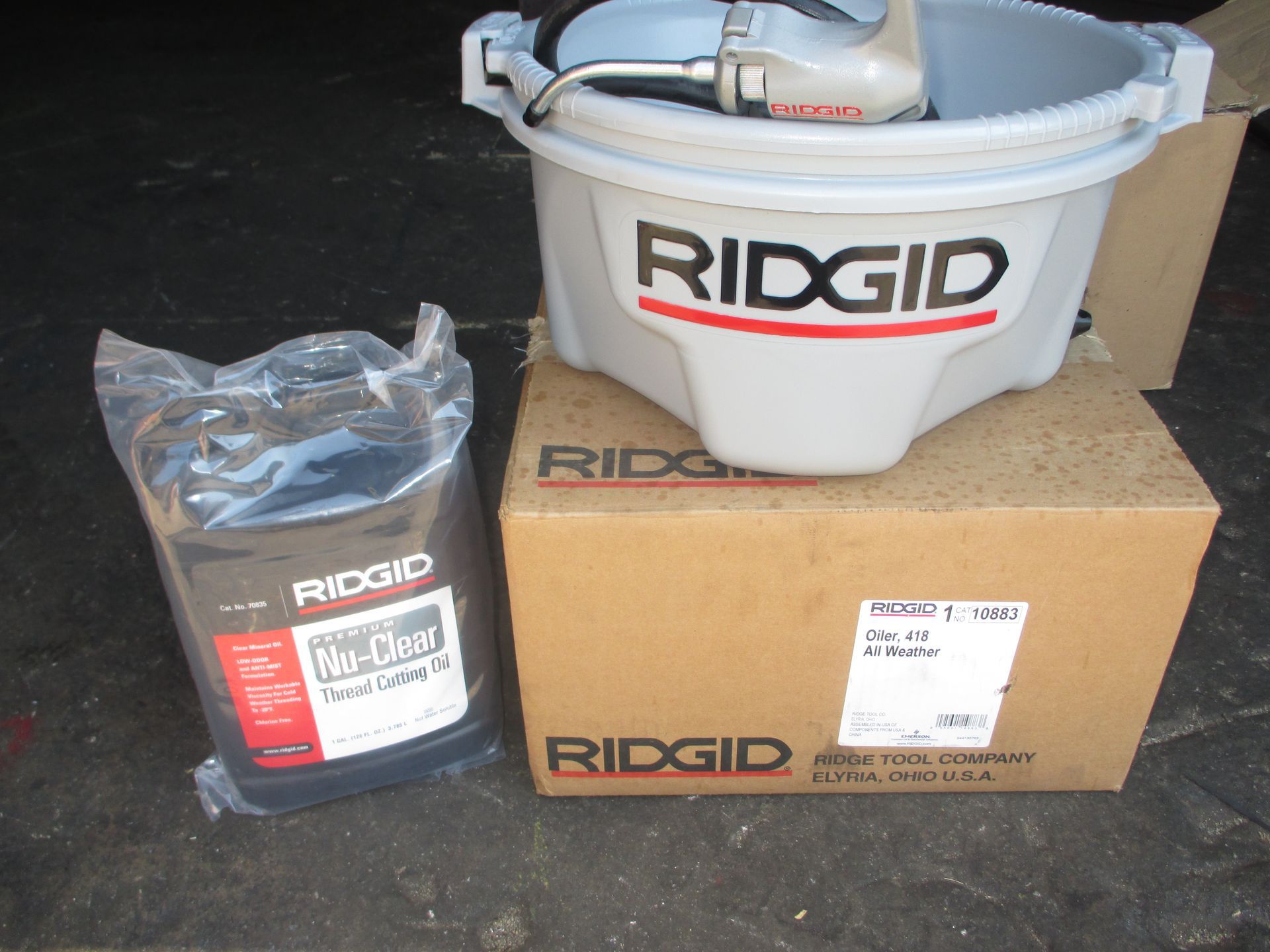 A ridgid bucket sits on top of a cardboard box