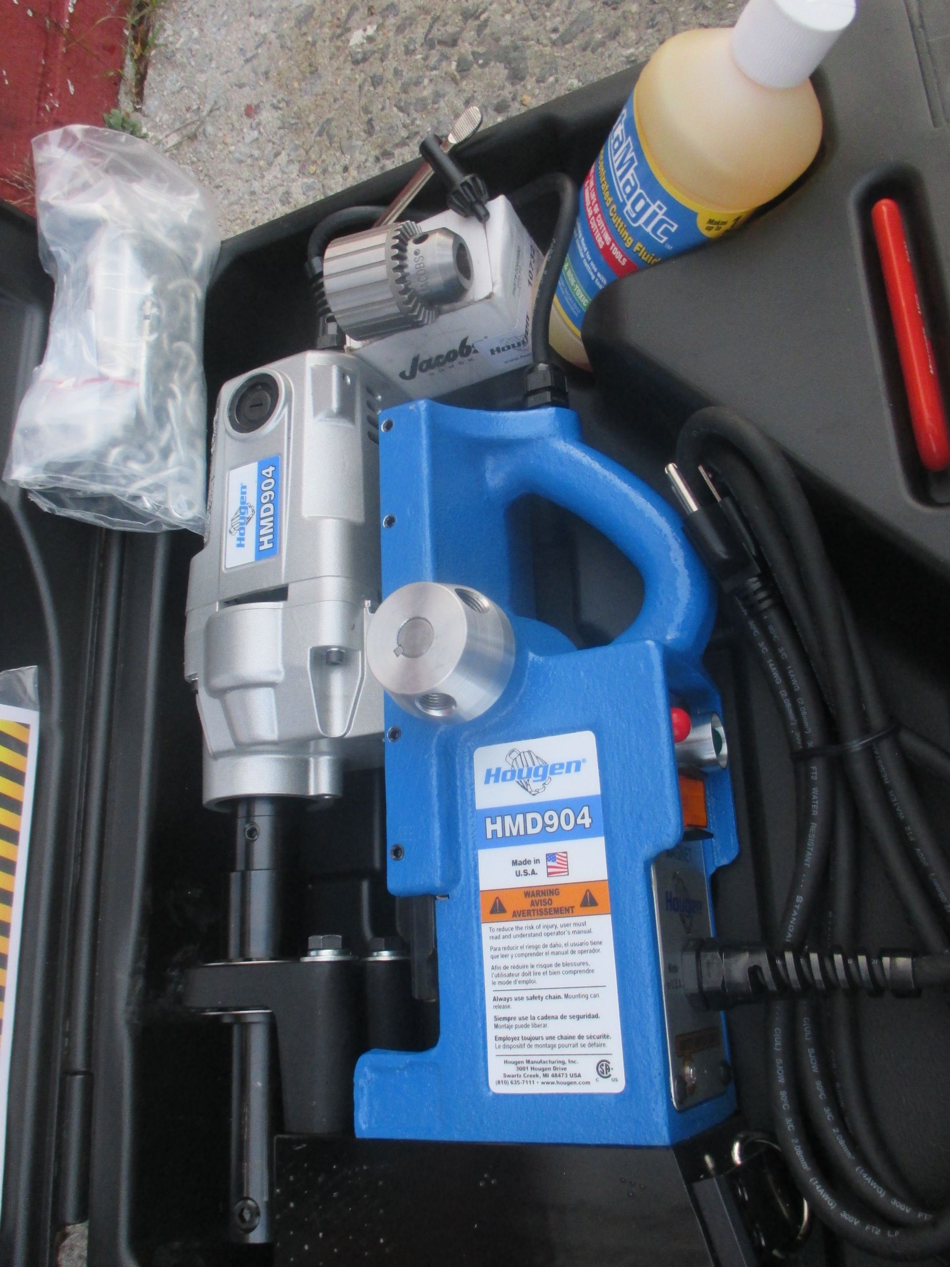 A blue and silver machine with a warning label on it