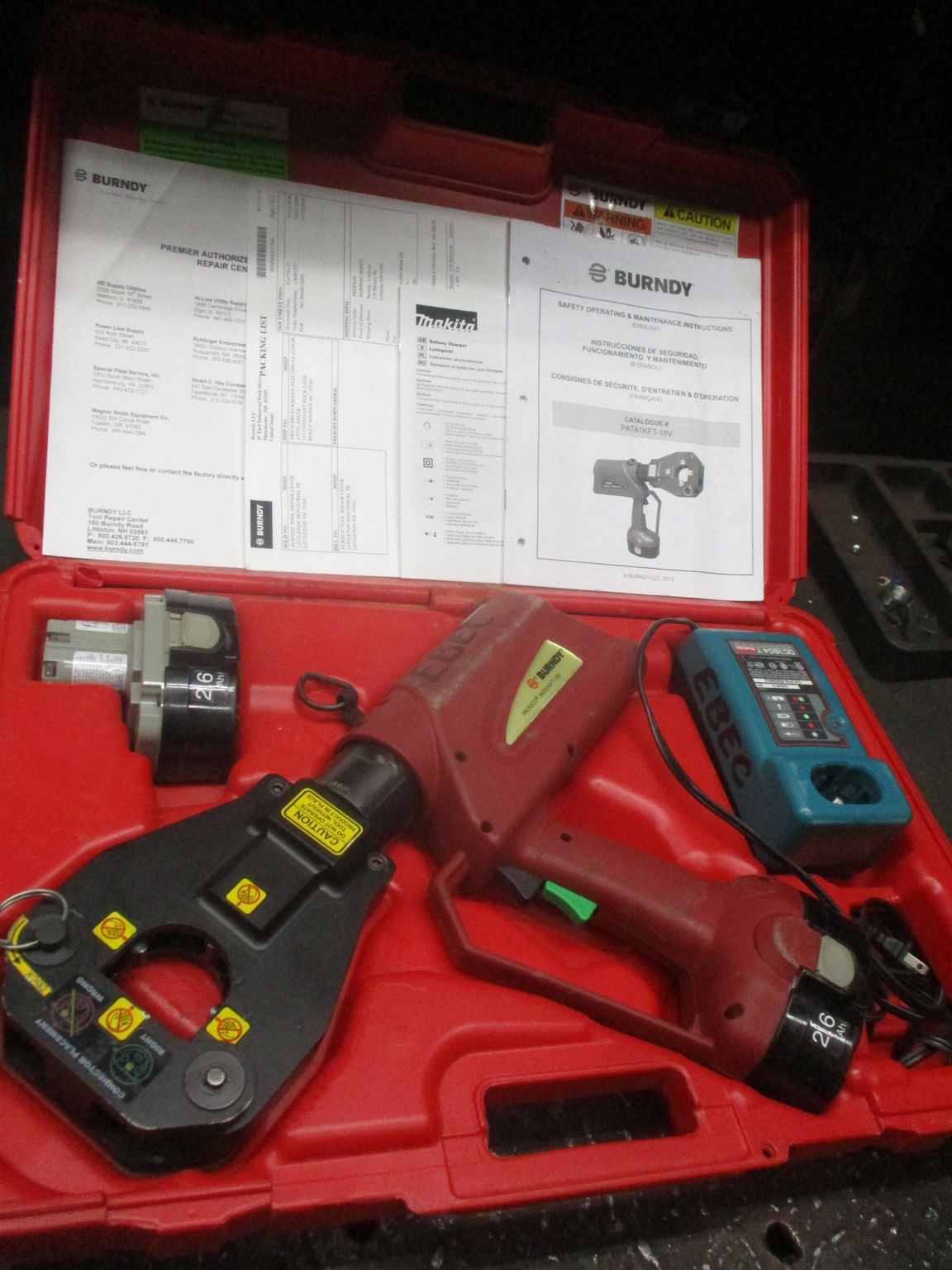 A red case with a bunch of tools inside of it