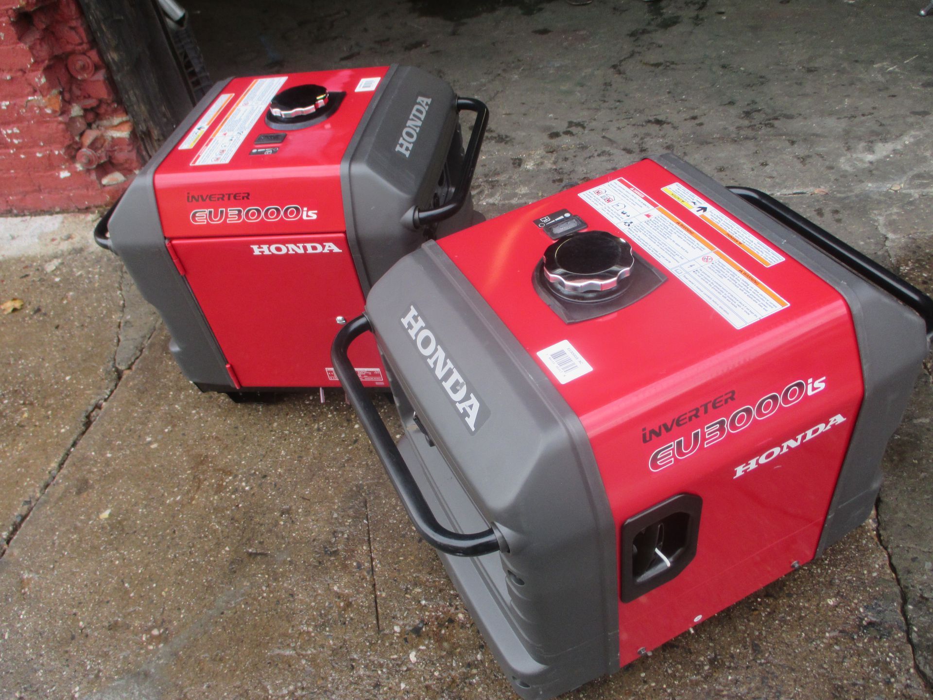 Two honda generators are sitting next to each other