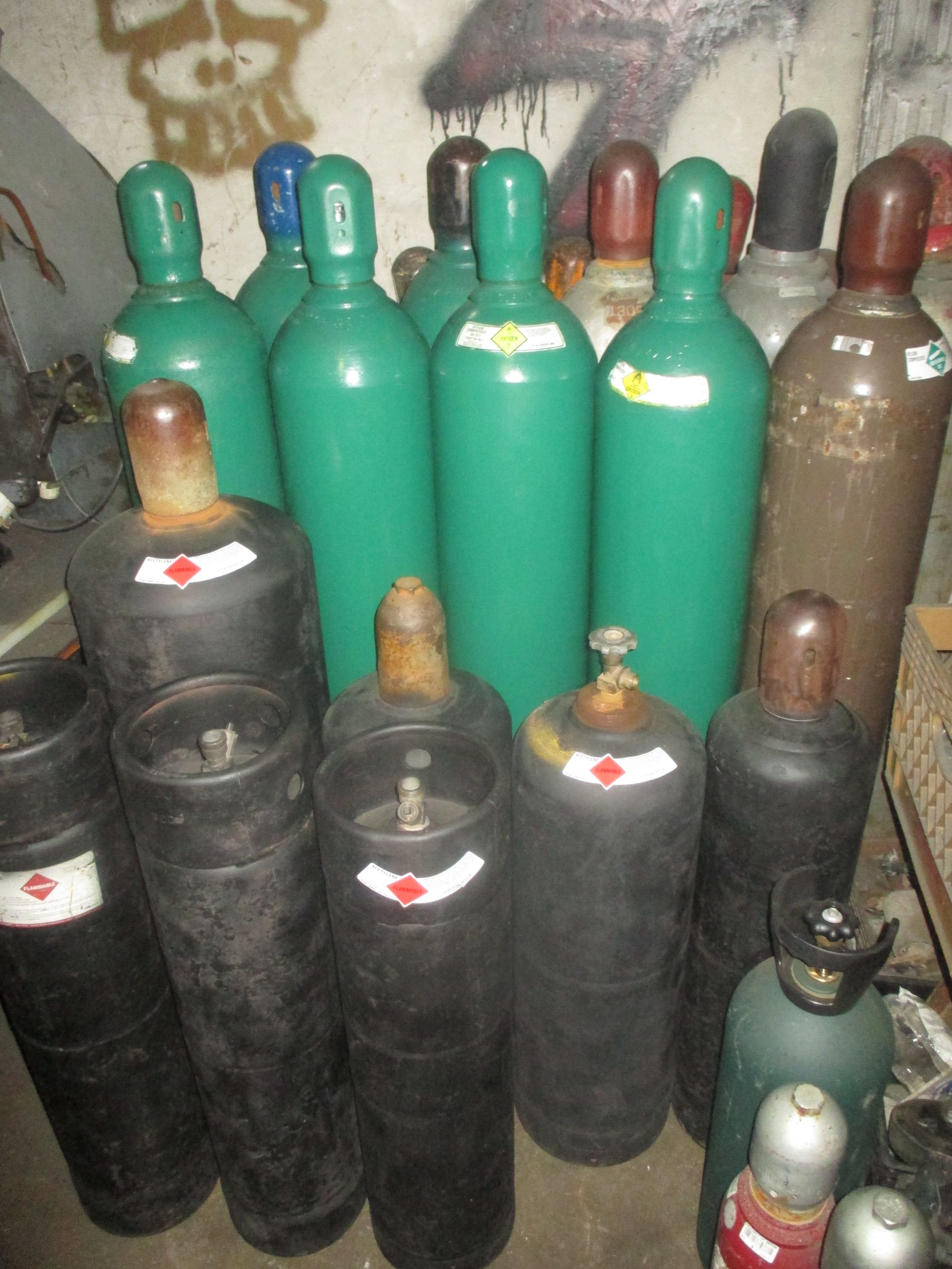 A bunch of gas cylinders are stacked on top of each other