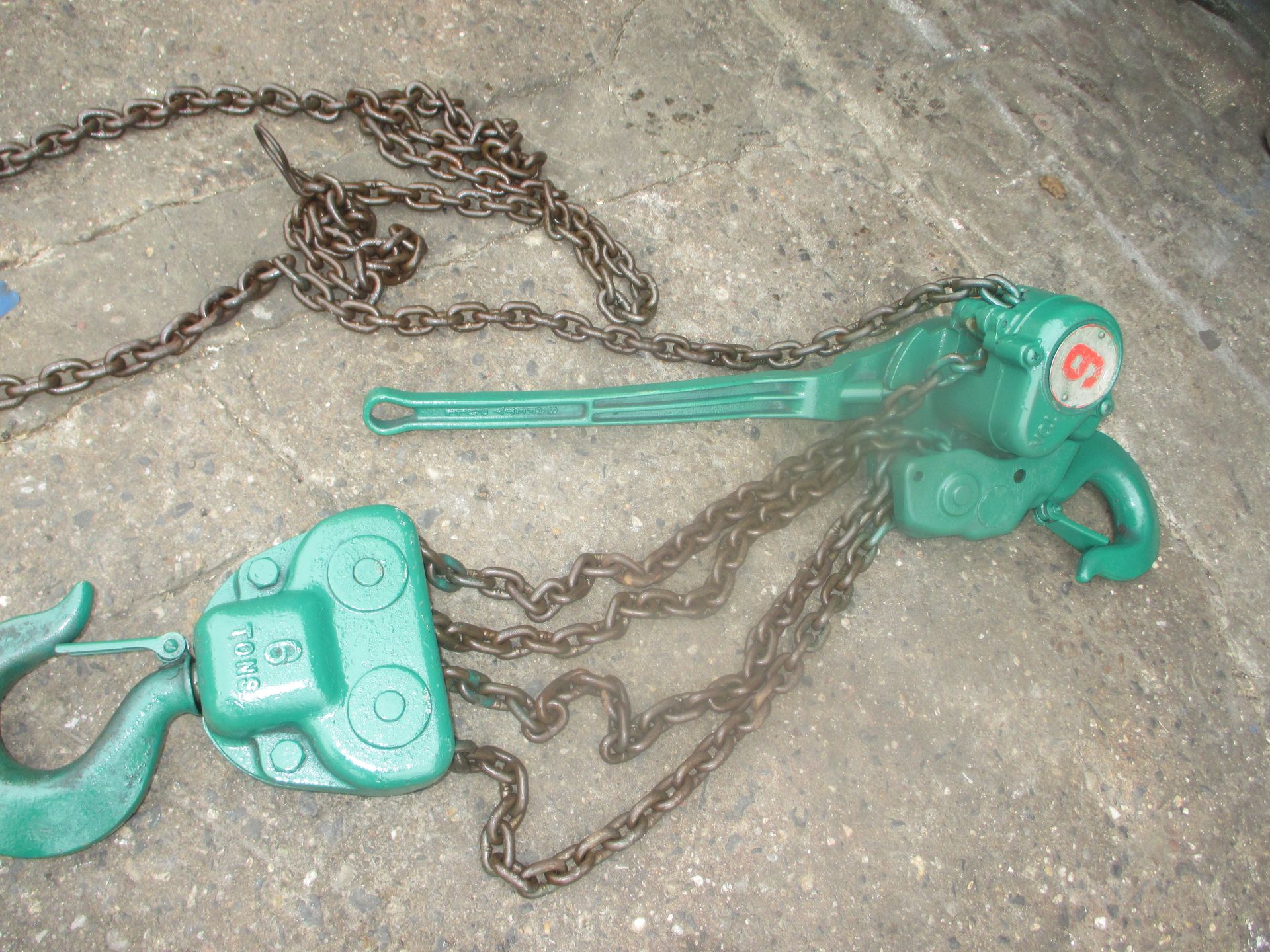 A green chain hoist with the number 8 on it