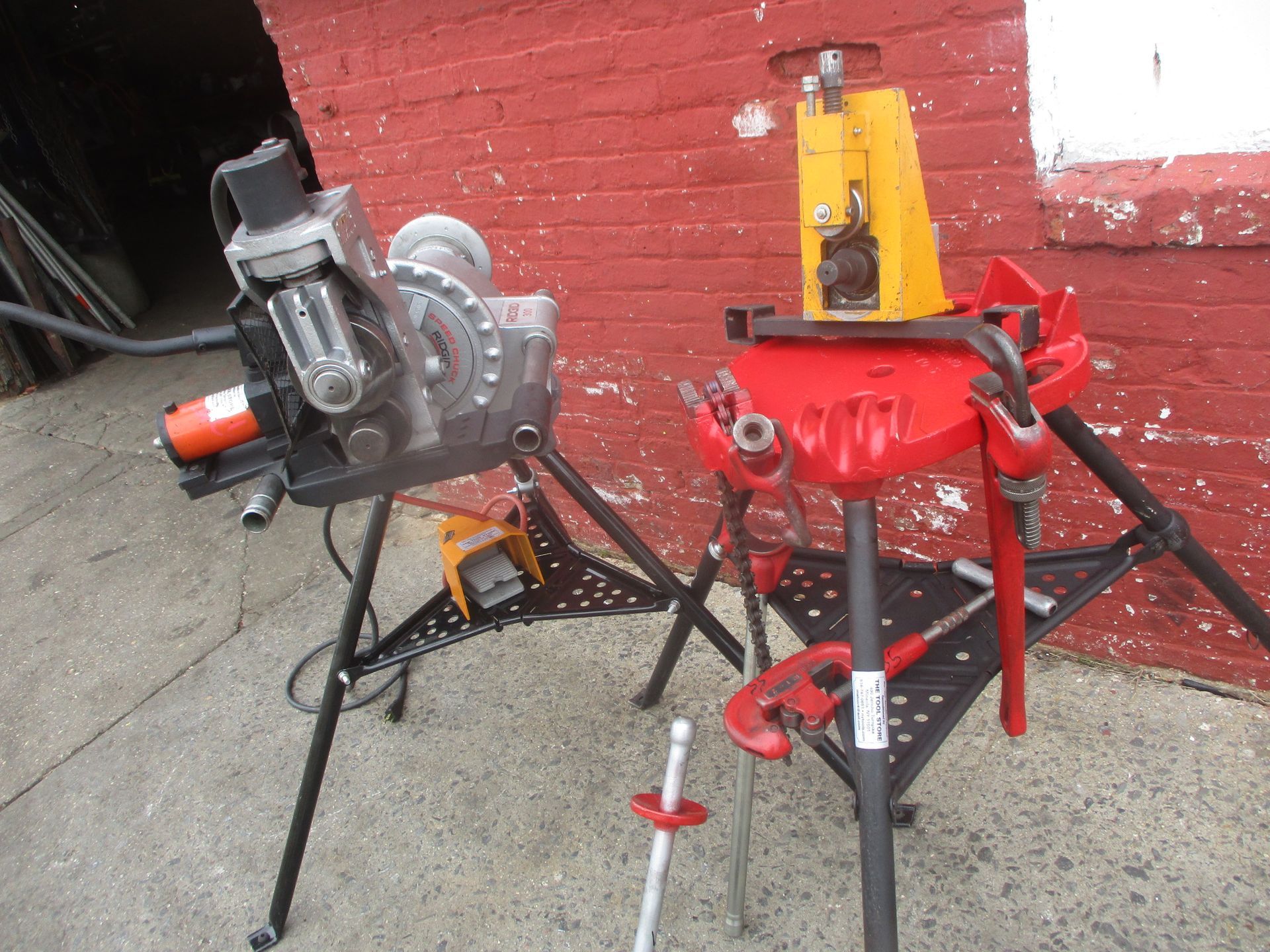 A couple of tools sitting on a table in front of a brick wall