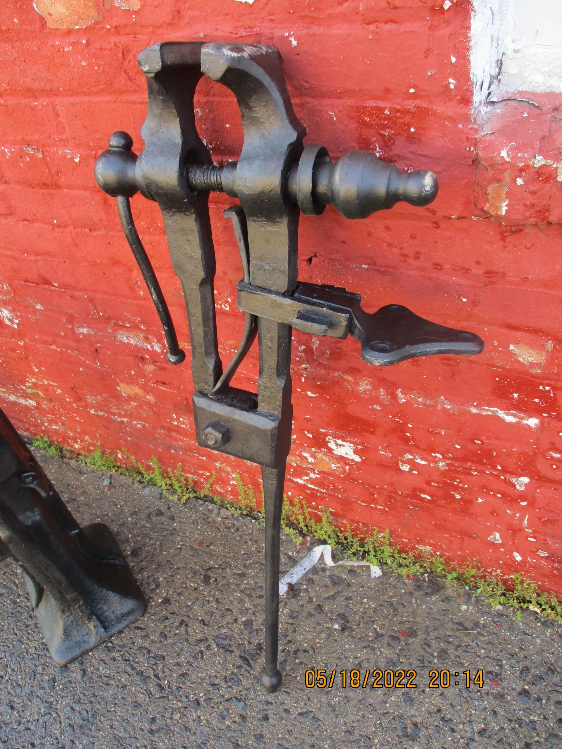 A red brick wall with a black tool on it