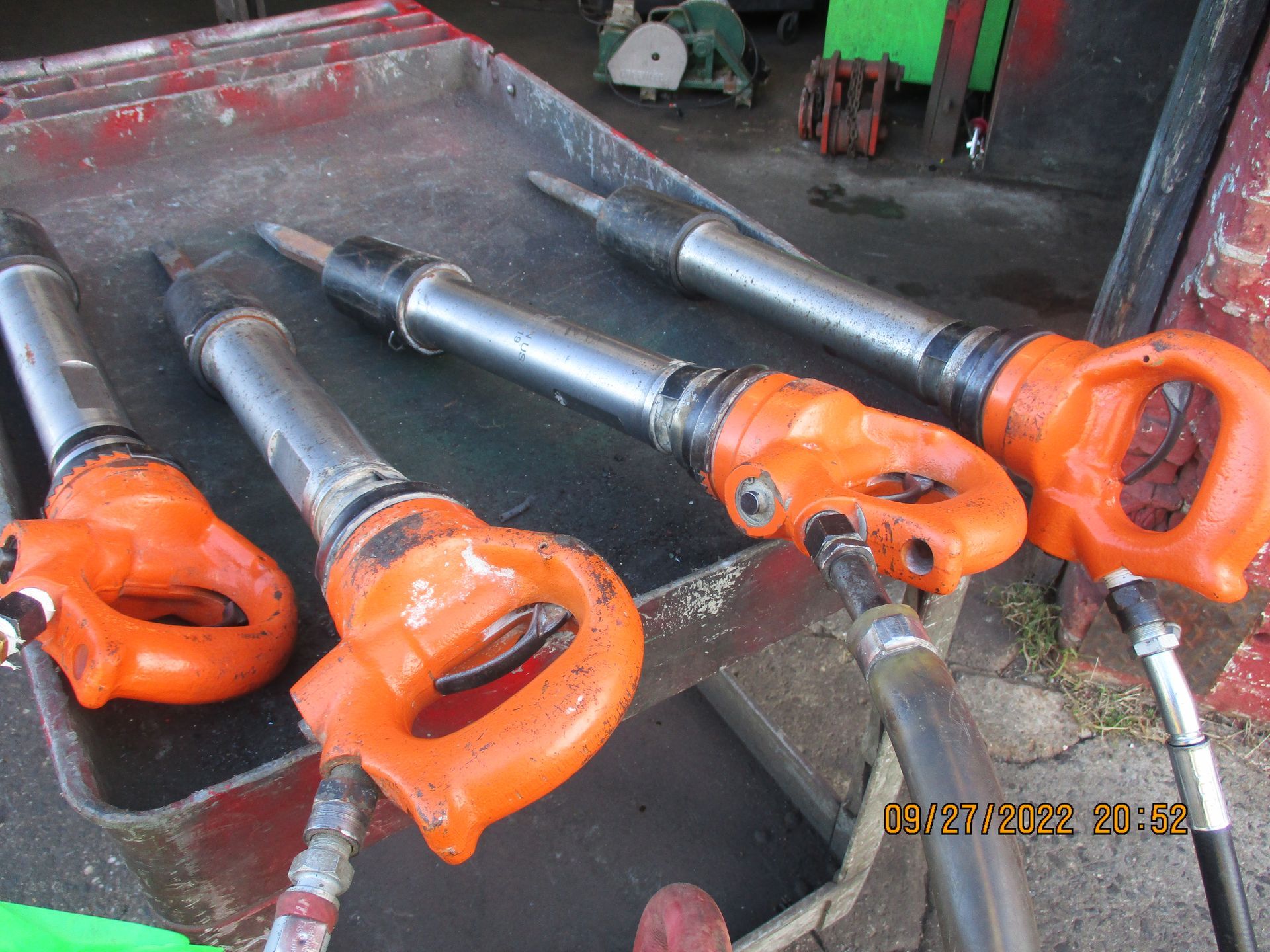 Three orange hammers are sitting on top of a tray