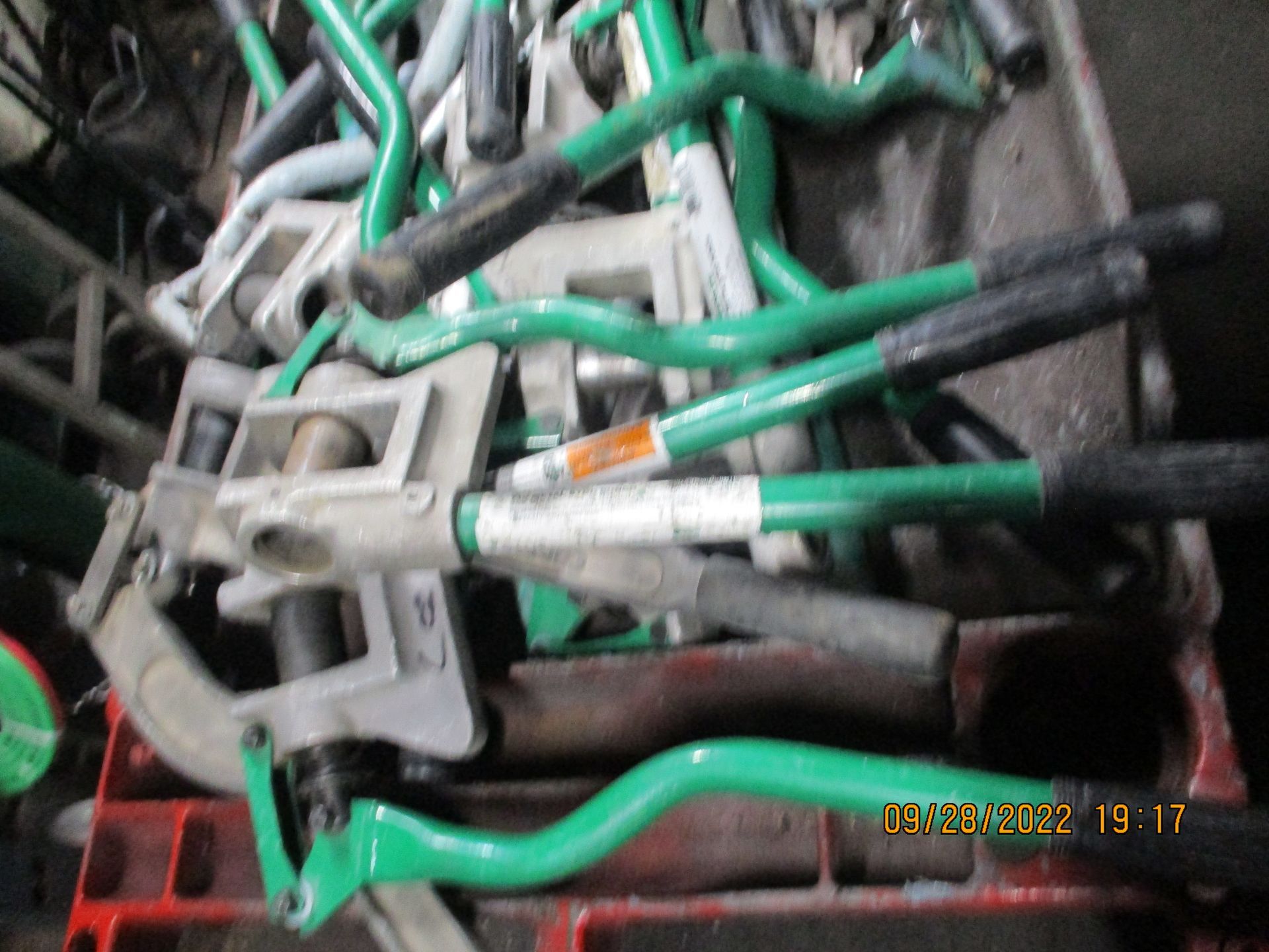 A bunch of green tools are stacked on top of each other