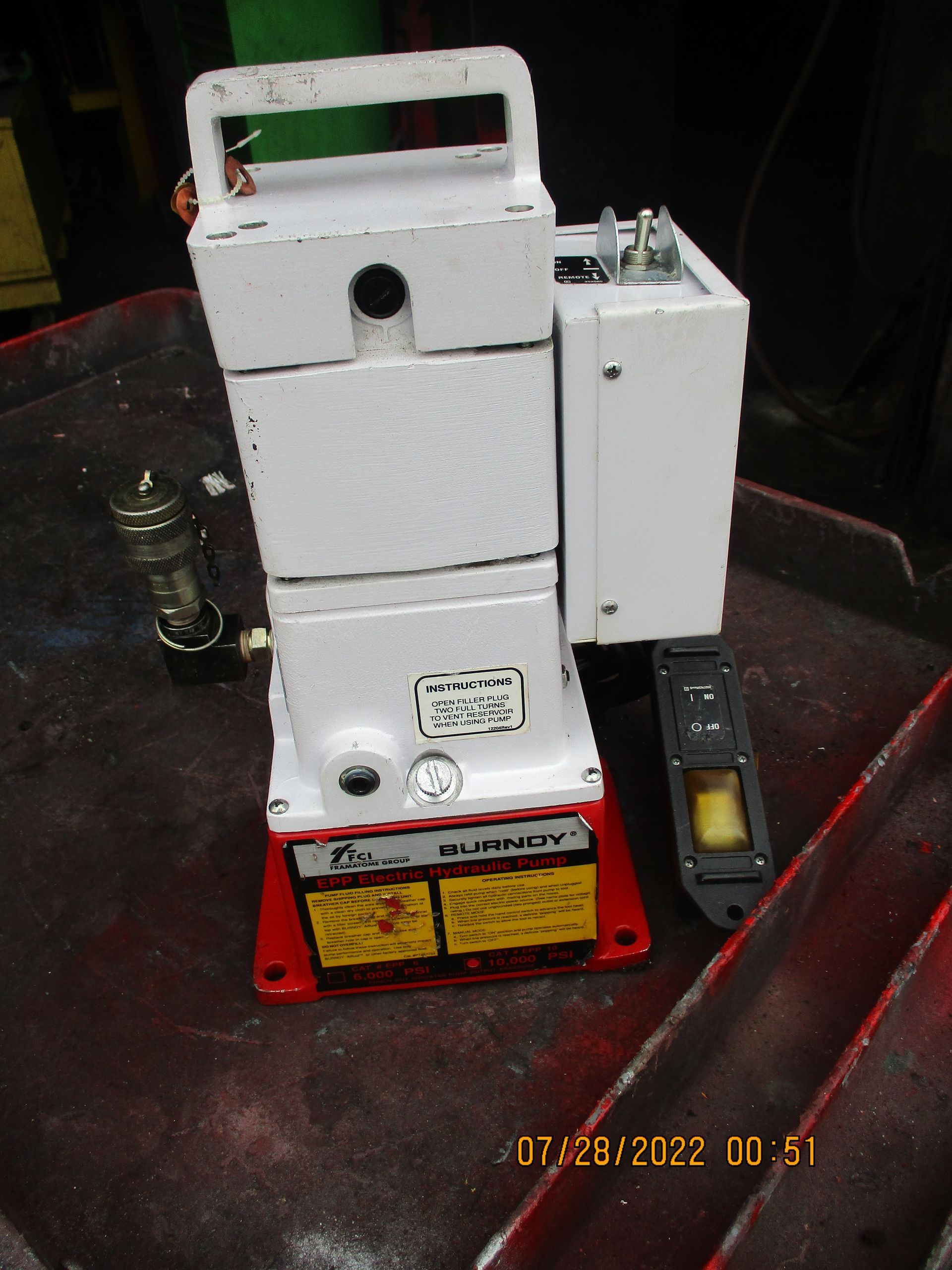 A white box with a red base is sitting on a table.