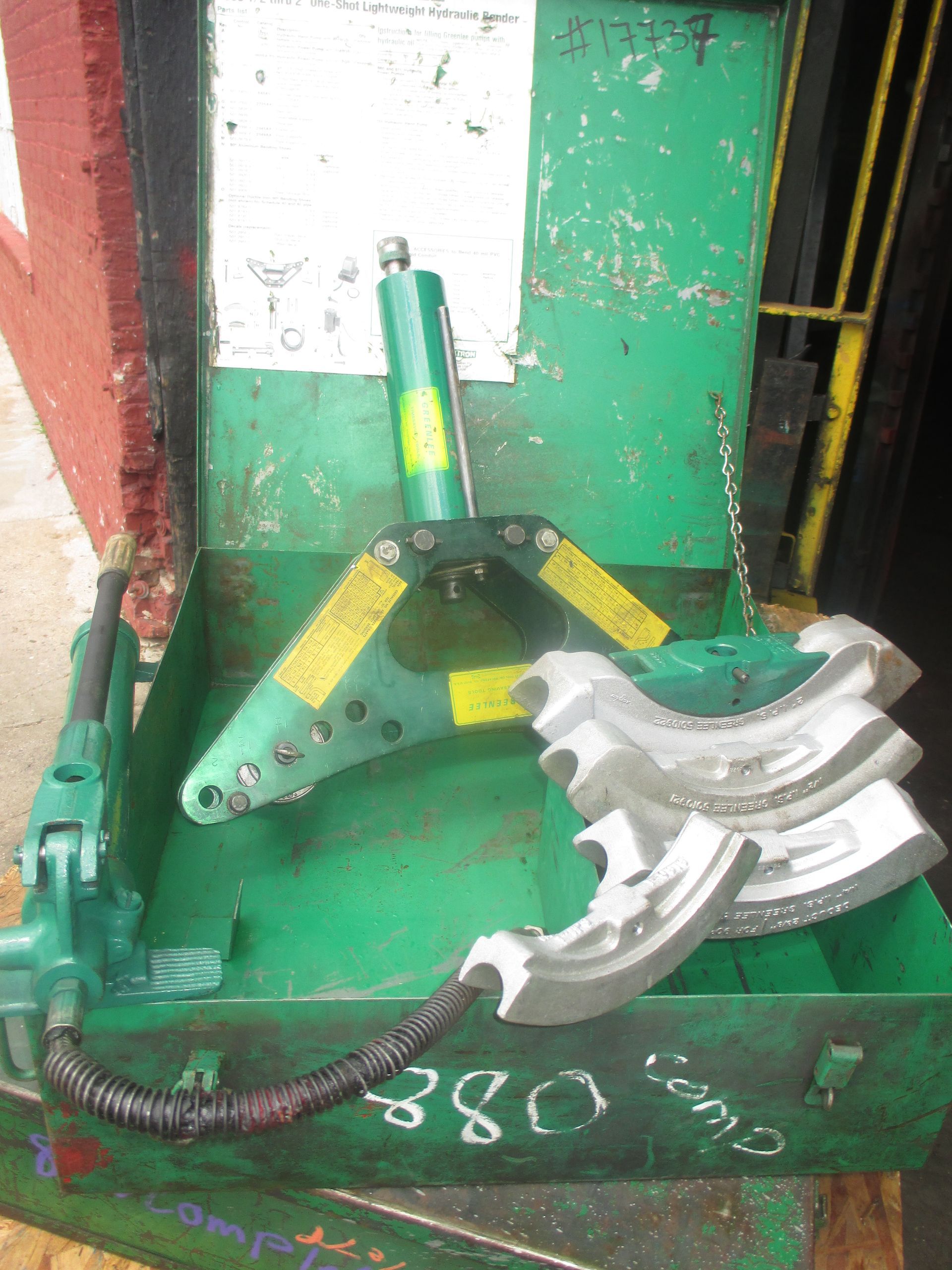 A green box with a bunch of tools in it