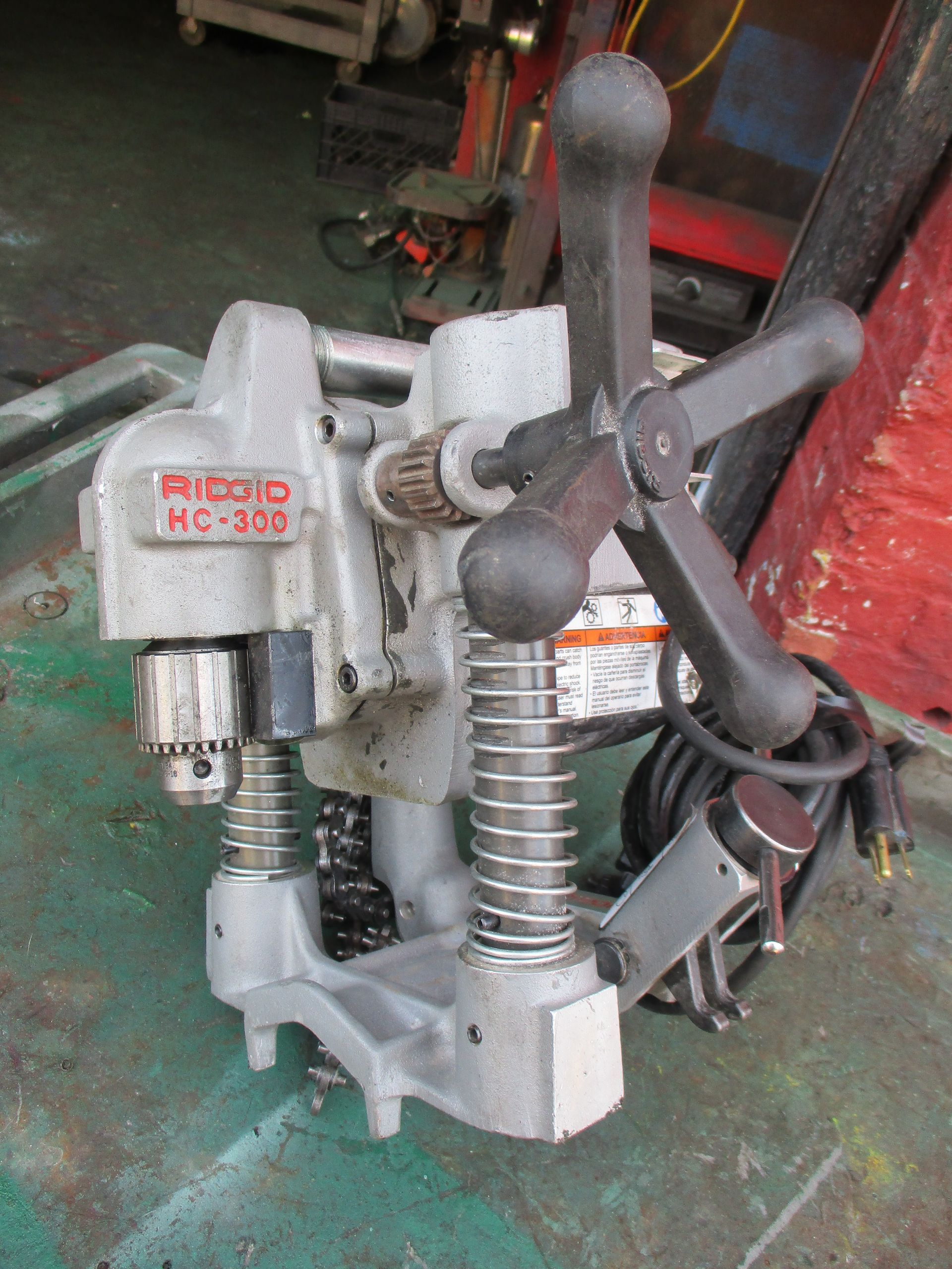 A machine with a drill attached to it is sitting on a table.