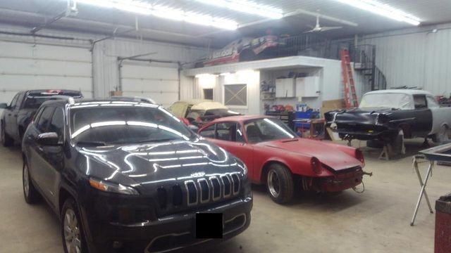 cars that are being repaired inside the shop