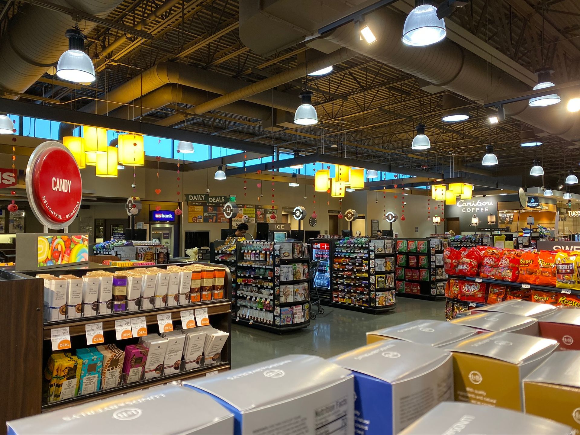 Grocery store interior with shelves of products and overhead lighting.