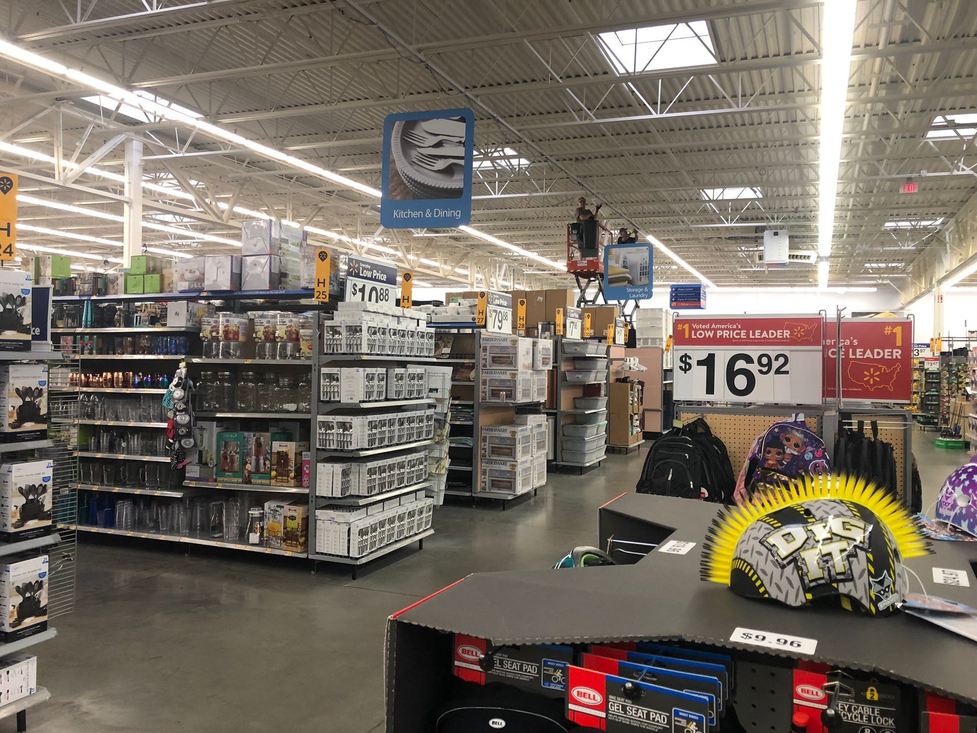 Interior of a Walmart store. Displays of merchandise are arranged in aisles under bright fluorescent lights.