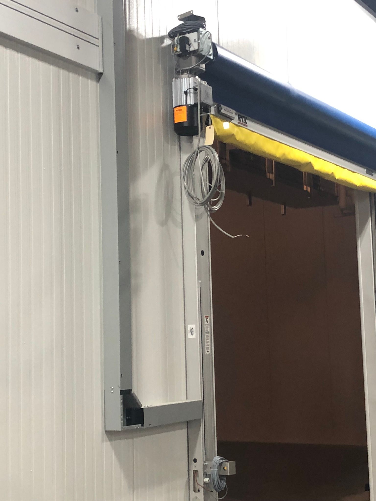 An automated sliding door mechanism, likely for a warehouse or industrial setting.