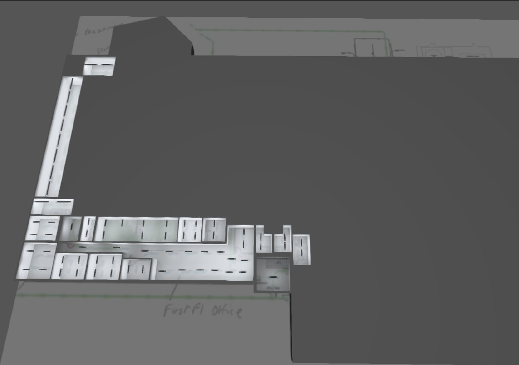 Overhead view of a gray building's floor plan, showing white rectangular structures on a gray background.