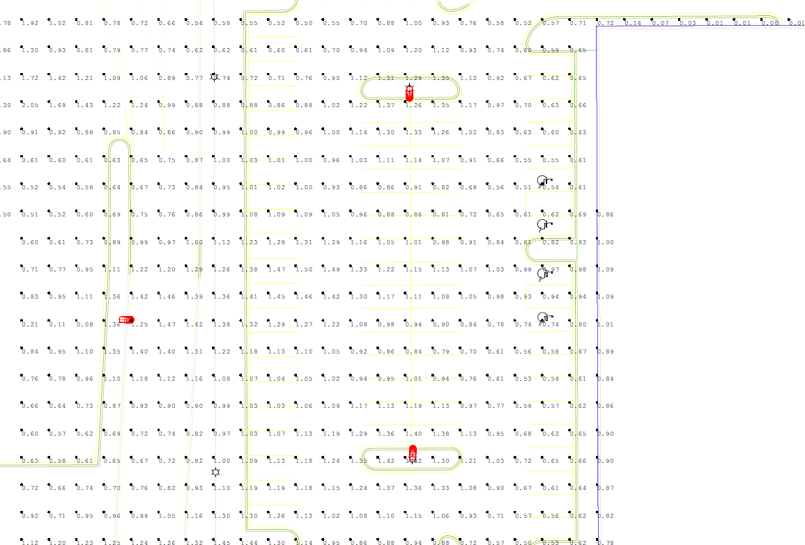 Overhead view of a grid-like layout with faint green lines and scattered text. Red markers and black arrows are also visible.