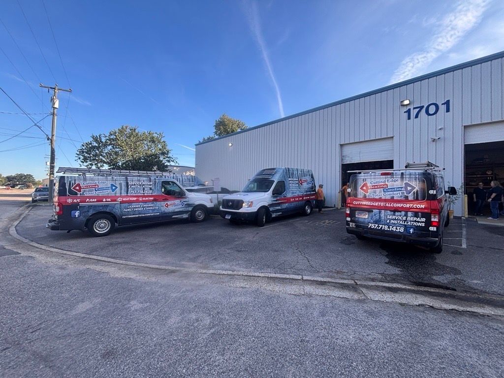 Tow trucks parked outside a white industrial building with number 1701 on the front.