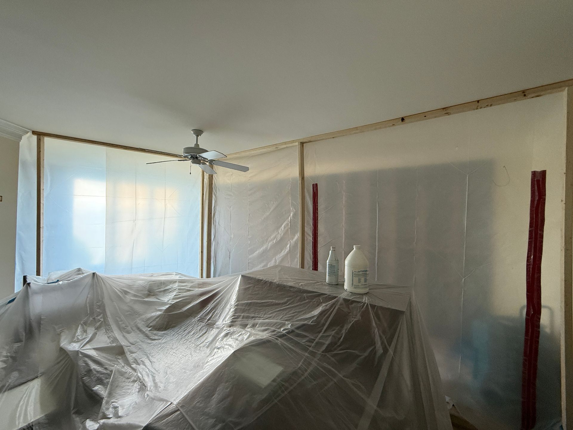 Room covered in plastic sheeting for renovation.
