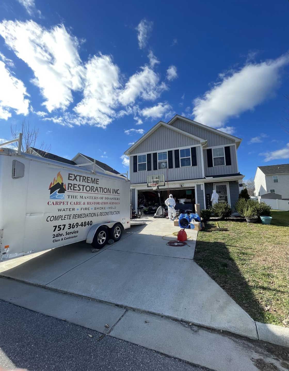 a white trailer is parked in front of a house