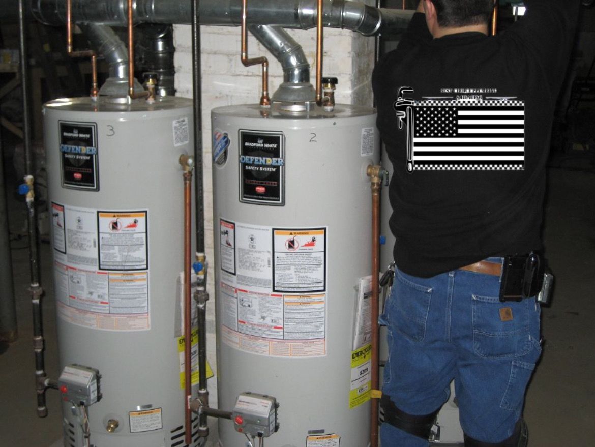 A man wearing an american flag shirt is working on a water heater