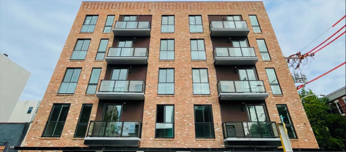 A large brick building with a lot of windows and balconies