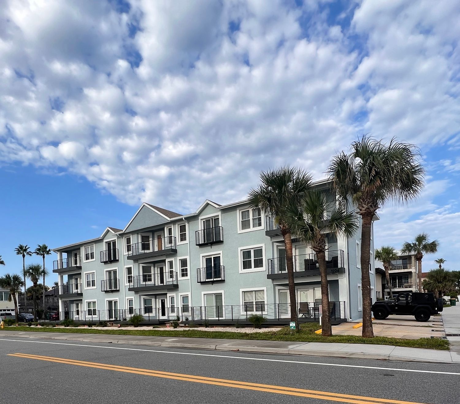 Interior entryway with staircase, hardwood floors, and double doors.