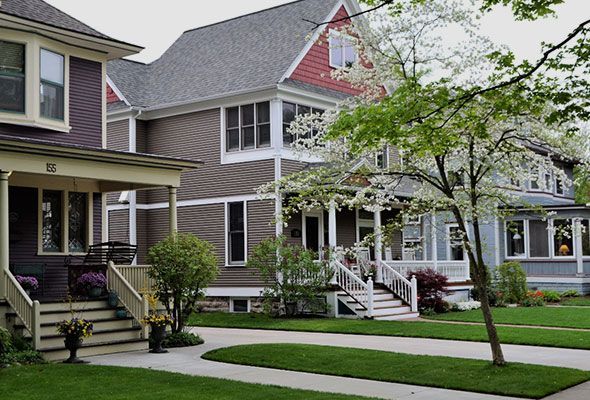 A row of houses with a lush green lawn