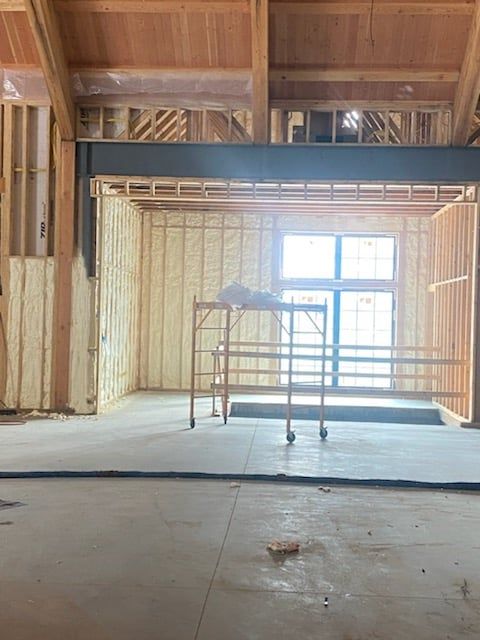 The inside of a building under construction with a scaffolding in the middle of the room.