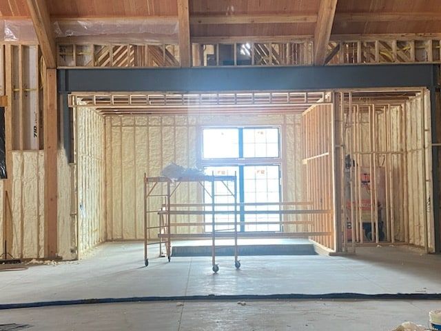 The inside of a building under construction with a large window.