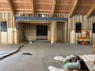 A large room with a ceiling that is being built.