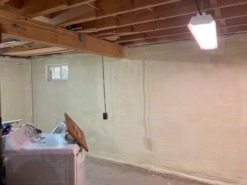 A laundry room with a washer and dryer and a light on the ceiling.