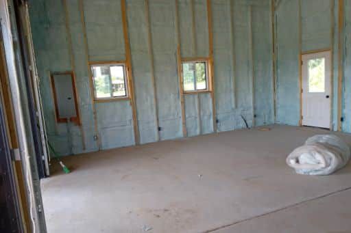 A room with a lot of insulation on the walls and a door.