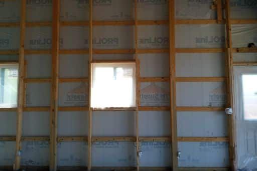 A room with a lot of wooden beams and a window.