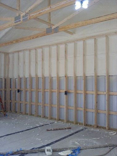 A large room with a lot of wooden beams and a ceiling.