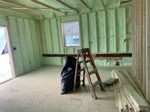 The ceiling of a house is covered in green spray foam.