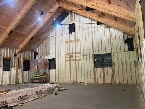 A large room with a wooden ceiling and walls is being built.