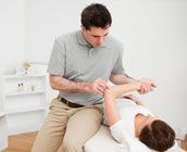 Therapist performing massage to a patient