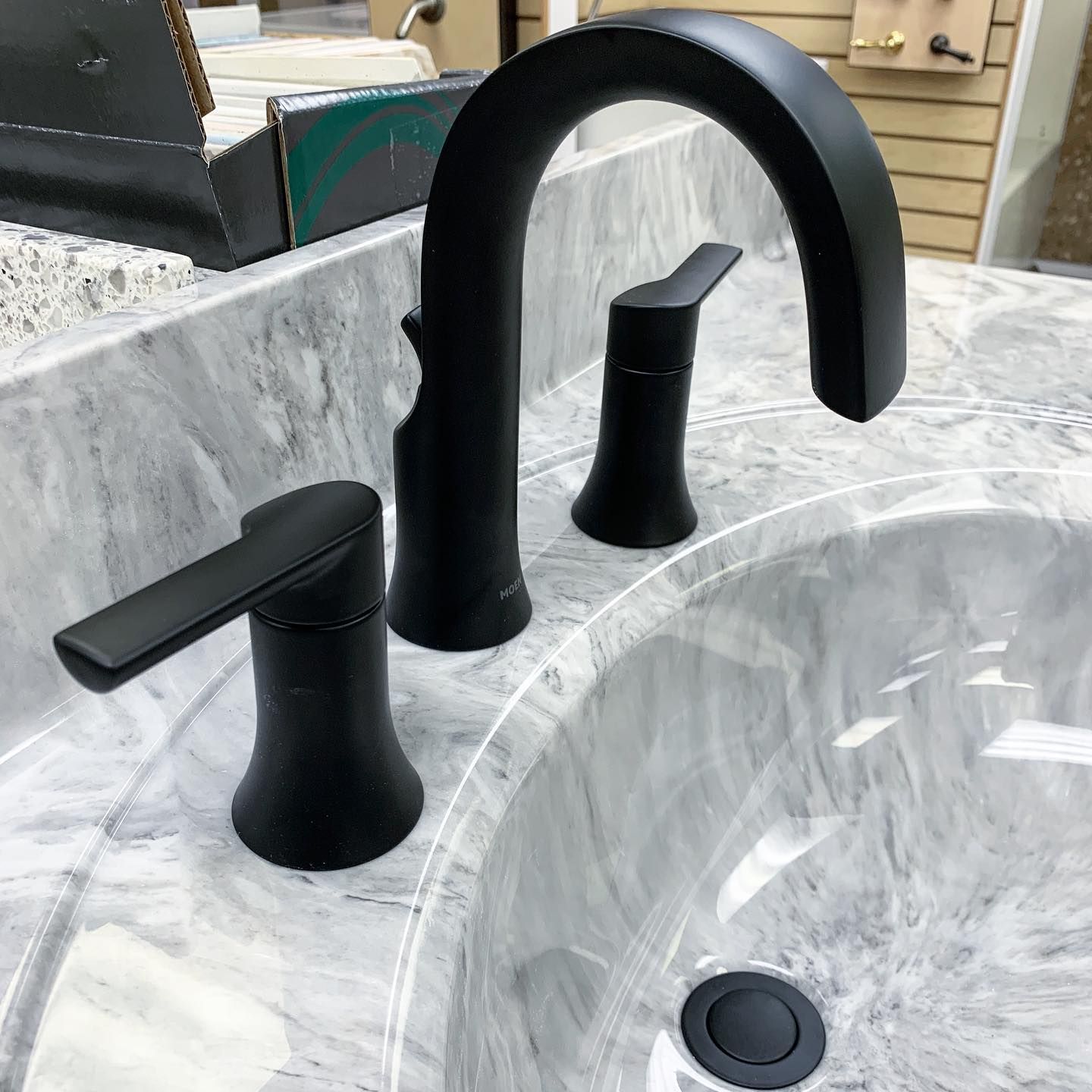 Black bathroom faucet on a marble countertop.