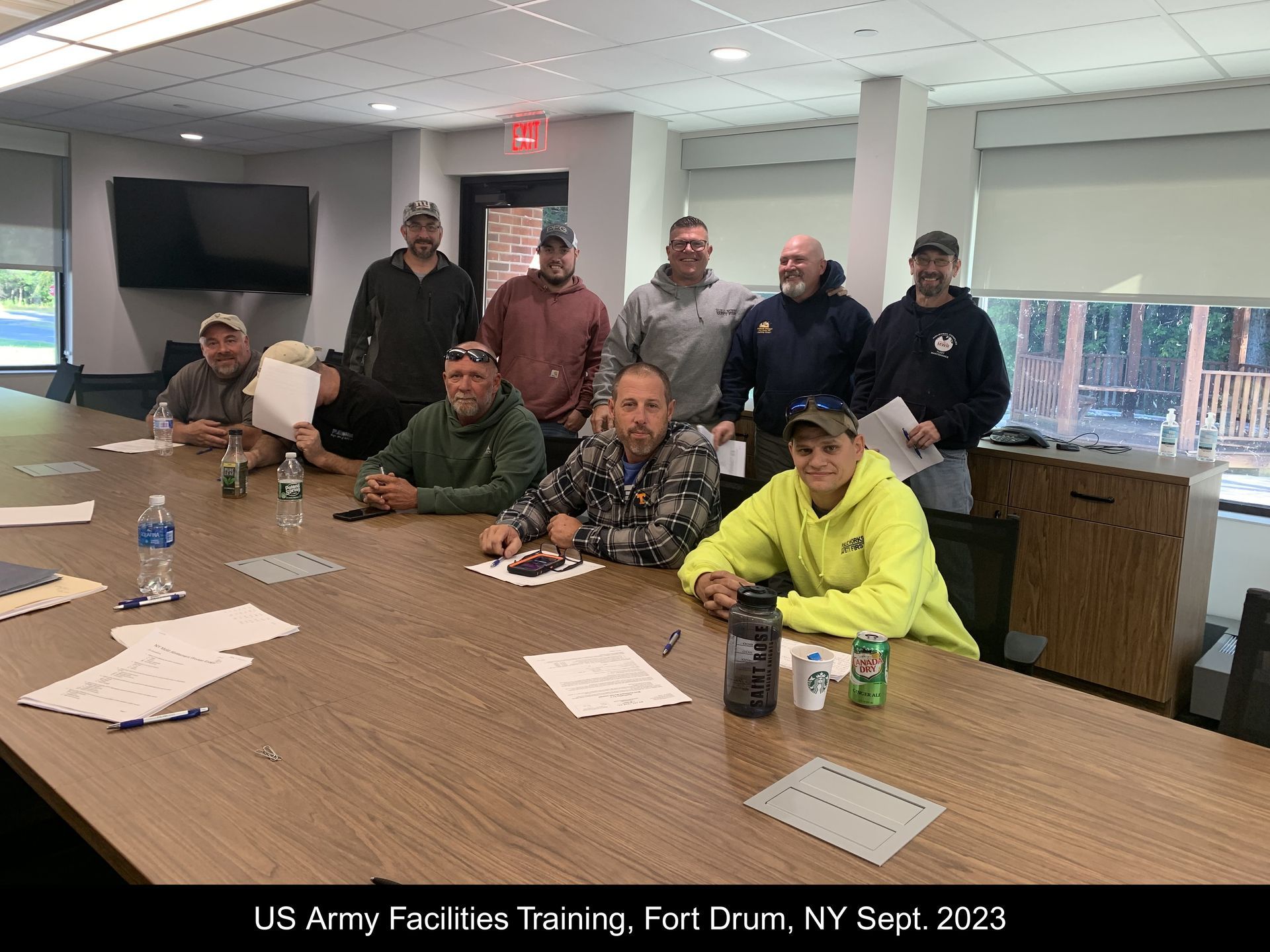 A group of men are sitting around a table in a room