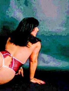 Woman in red lingerie, black hair, posing against a blue and black background.
