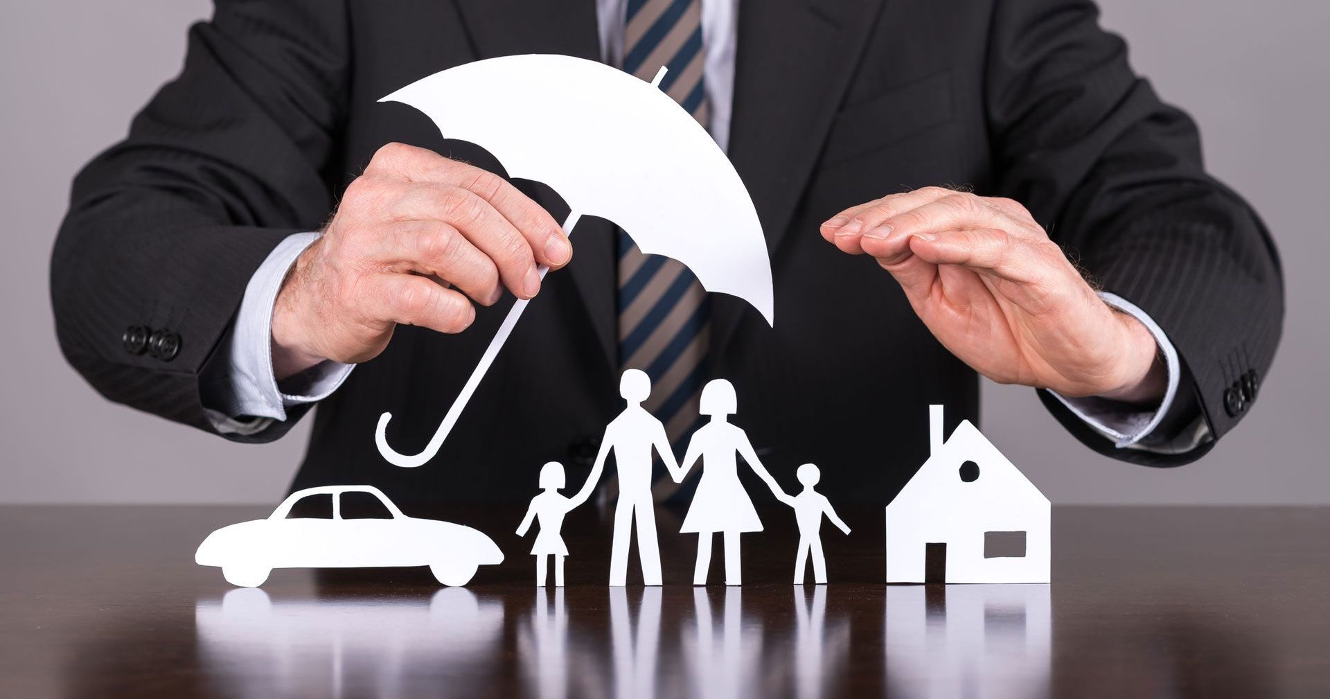 Man arranging blocks labeled with financial terms, topped with a dollar.