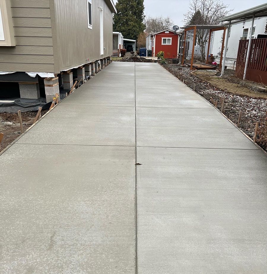 Newly poured concrete driveway between mobile homes.